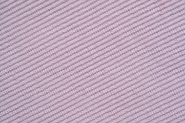 pink texture of knitted synthetic fabric as a background, pink smooth symmetrical lines of synthetic fabric