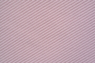 pink texture of knitted synthetic fabric as a background, pink smooth symmetrical lines of synthetic fabric