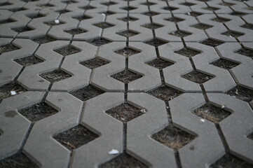 Background texture of square tiles made of gray natural stone. Concrete street covering of road,...