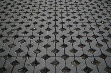 Background texture of square tiles made of gray natural stone. Concrete street covering of road,...