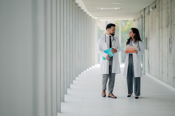 Doctors walking and discussing in hospital corridor