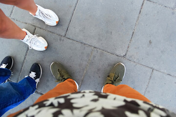 Aerial View of Unrecognisable Individuals Wearing Sneakers on City Street with copy space