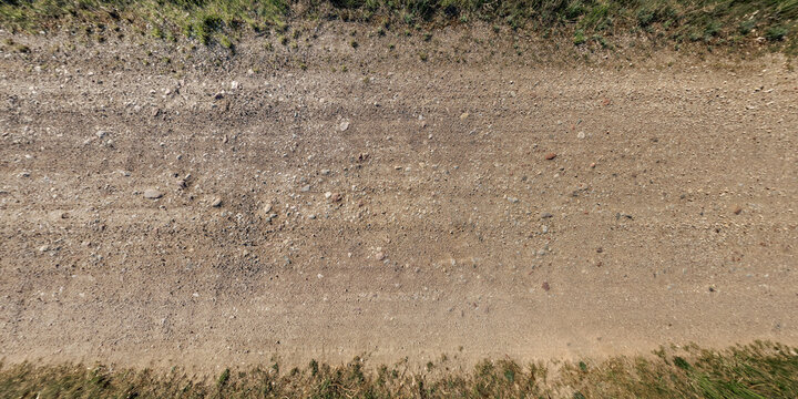 top view of gravel road surface and grass shoulder