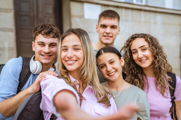 Fototapeta premium group of happy classmates take a self portrait and in front of school