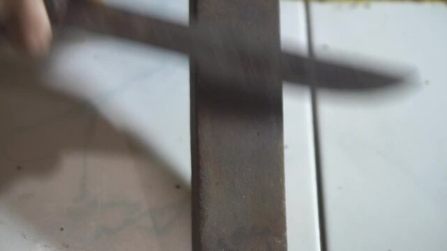 a man is sharpening a knife in the traditional way