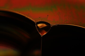 Oil production, brown bubbles in macro, texture of viscous black liquid, oil in laboratory