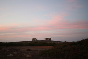 House on the cape on the hills during sunset