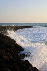 Ocean waves crashing onto rocky beach