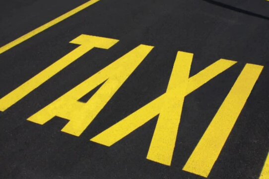 yellow road taxi sign