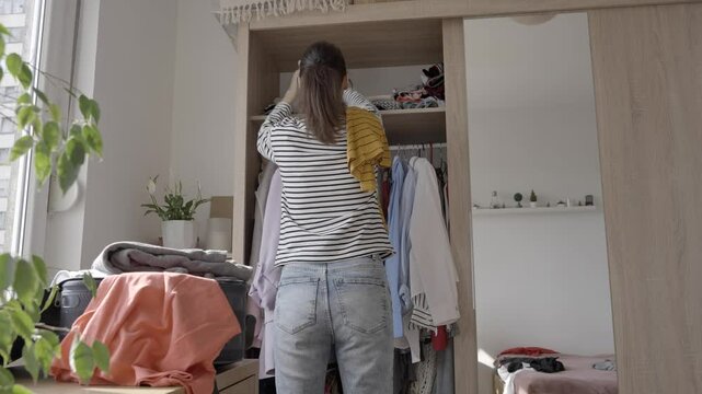 Wardrobe dilemmas, Woman deciding what to wear
