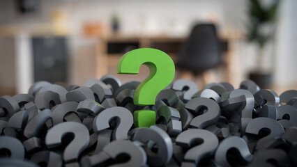 A close-up photograph of multiple gray question marks scattered across the frame, with a single bright neon green question mark standing out prominently in the center.