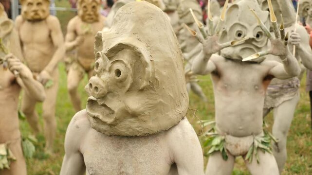 Asaro Mudmen tribe. Papuan tribe dance. Mount Hagen tribe festival. Cultural event. Indigenous men in native costumes. High quality 4k footage