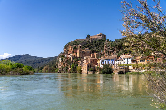Miravet, Spain: A riverside village with a castle perched atop a rocky cliff.
