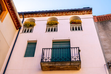 Facade of a building with flower boxes and a balcony.