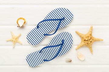 Striped blue flip flops on wooden background, top view