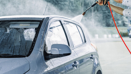 Car washing. Car cleaning soap foam. Spray bubbles pressure wet shine.