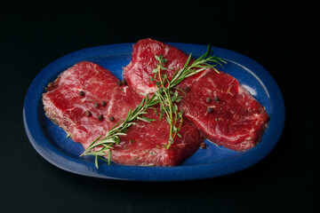 Raw Steaks on Blue Plate