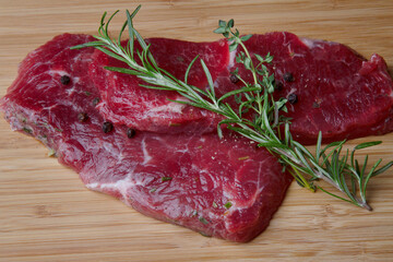 Whole Raw Tenderloin beef meat for steaks fillet mignon on a wooden cutting board