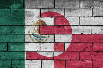 colourful painted big national flag of mexico and flag of greenland on a massive old brick wall background. concept