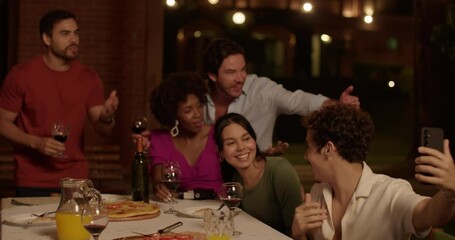 Group of diverse friends having fun drinking wine and taking selfie during pleasant evening dinner. - Powered by Adobe