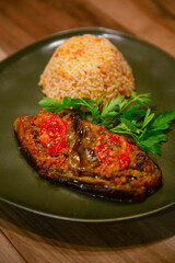 Traditional turkish bulgur pilaf with tomato sause in plate and Stuffed Eggplants