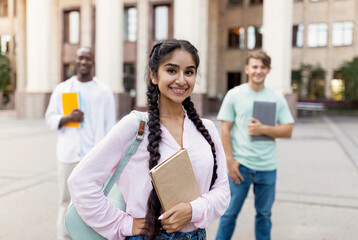 Future professionals. Portrait of multiracial university students posing outdoors near university...