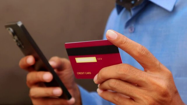 man with credit card and mobil phone