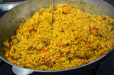 Delicious pot of traditional pilaf with vegetables and meat, cooked to perfection with savory...