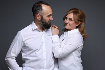 Portrait of lovely couple on grey background