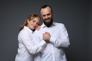 Portrait of lovely couple on grey background