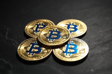 Cryptocurrency. Bitcoins on black table, closeup view