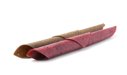 Delicious fruit leather rolls on white background