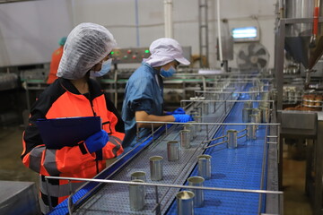 Food engineer working in the food factory for check production line