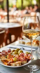 Delicious Tapas Platter with White Wine Glass Outdoor Restaurant Setting