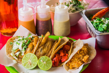 An exquisite arrangement of tacos served with an array of condiments and fresh sides, promising a satisfying culinary experience for food enthusiasts.