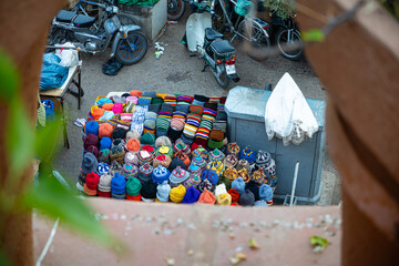 Colorful hats displayed for sale in a market.