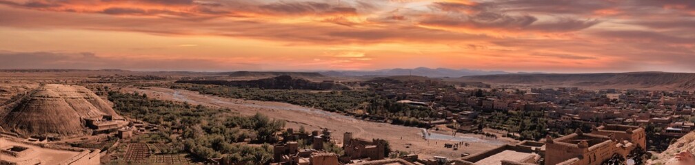 Arid landscape,  adobe structures,  dry hills.