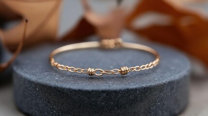 Elegant Gold Bracelet on a Textured Stone Surface