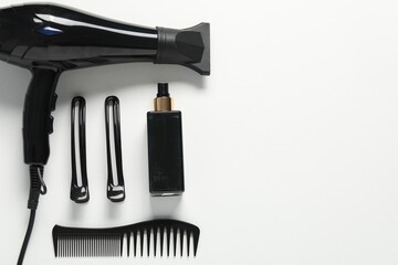 Naklejka premium Different hairstyling tools on white background, flat lay. Space for text