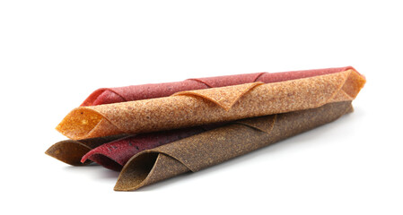 Delicious fruit leather rolls on white background
