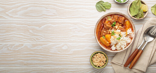 Aromatic massaman curry, a staple of thai cuisine, with tender beef, potatoes, and fluffy rice, garnished with peanuts and fresh herbs, a vibrant and flavorful dish of Thailand