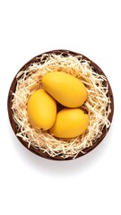 Overhead shot of juicy yellow mangoes in a rustic woven basket on a white background.
