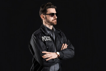 Male police officer on black background