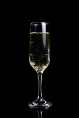 The glass of champagne on a black background