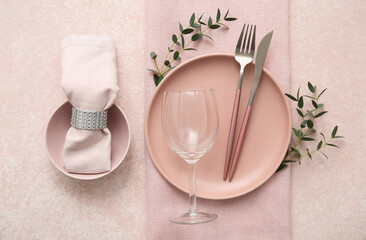 Beautiful table setting with eucalyptus branches on beige background