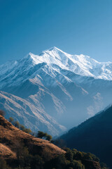 Fototapeta premium breathtaking view of majestic mountains in nepal under clear blue sky with sunlight illuminating peaks