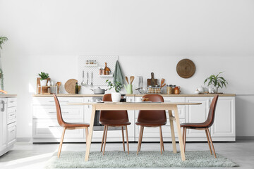 Interior of kitchen with counters, utensils and dining table