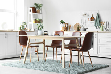 Interior of kitchen with counters, utensils and dining table