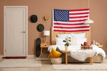 Interior of bedroom with USA flag, cowboy hats and bench