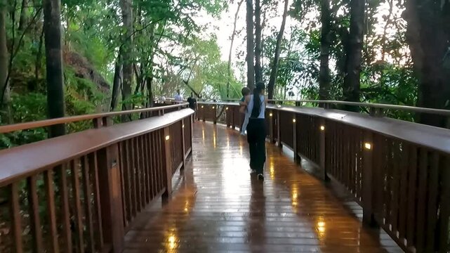Video of a mother at Mumbai's skywalk along with her toddler. Nature trail, malabar hill, tourism, tourist, tickets, booking, online, wooden, gallery, view, sea, marine.